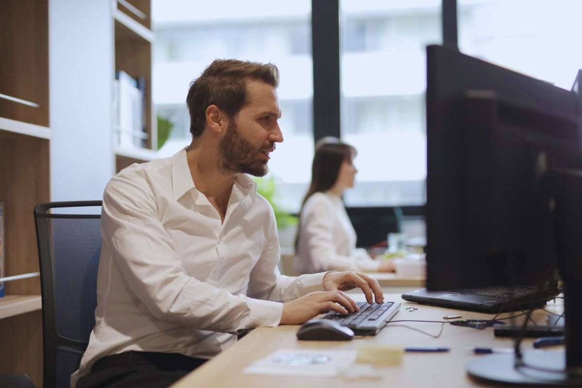 Uomo perplesso mentre lavora al PC